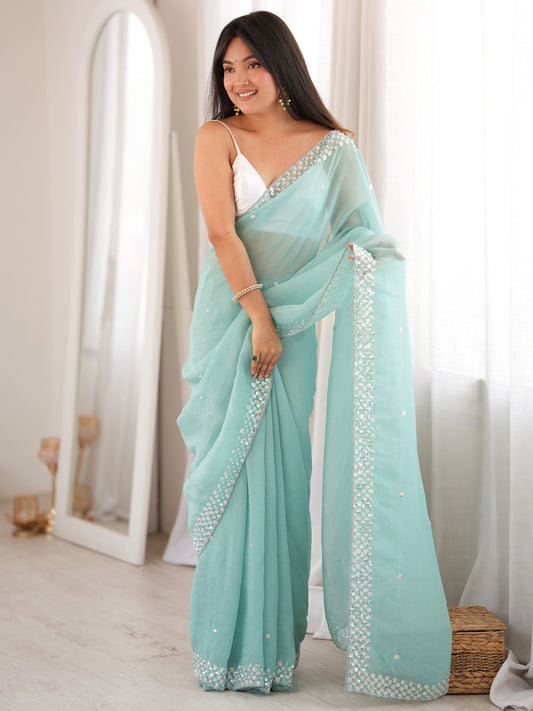 Woman wearing light blue georgette saree with embroidered motif work and white blouse