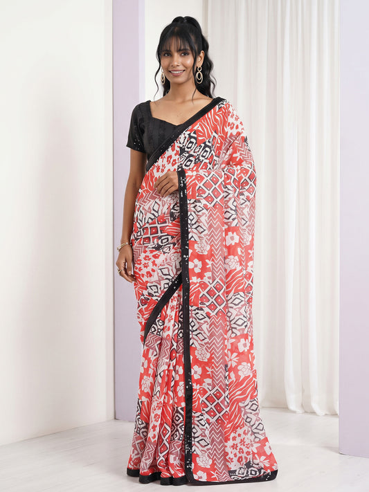 Woman wearing orange pure georgette saree with abstract contemporary design and black blouse