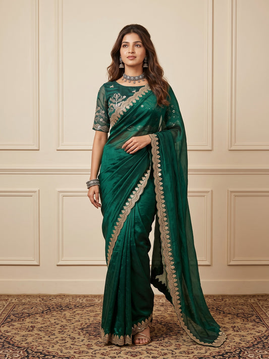 Woman wearing green tissue saree with ornamented surface design and green blouse