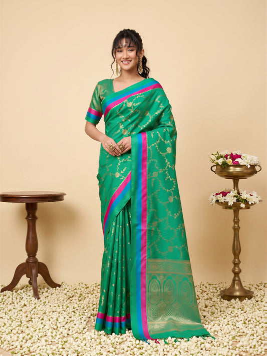 Woman wearing teal green pure silk saree with traditional indian motif work and teal green blouse