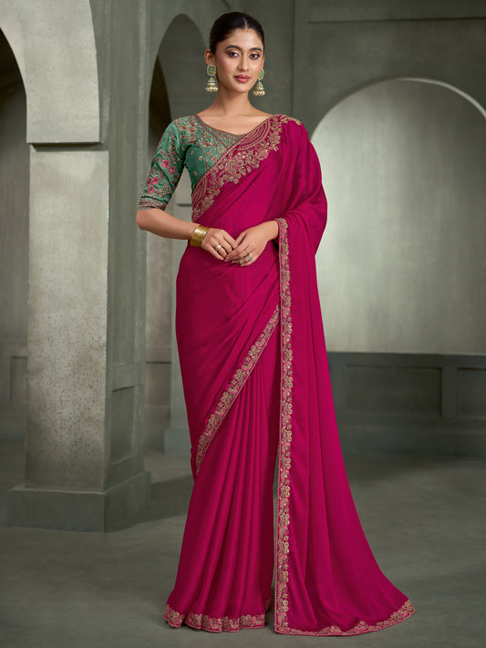 Woman wearing pink chiffon saree with embroidered motif work and light blue blouse