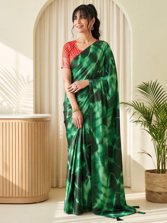 Woman wearing green satin silk saree with tie-and-dye resist pattern and red blouse