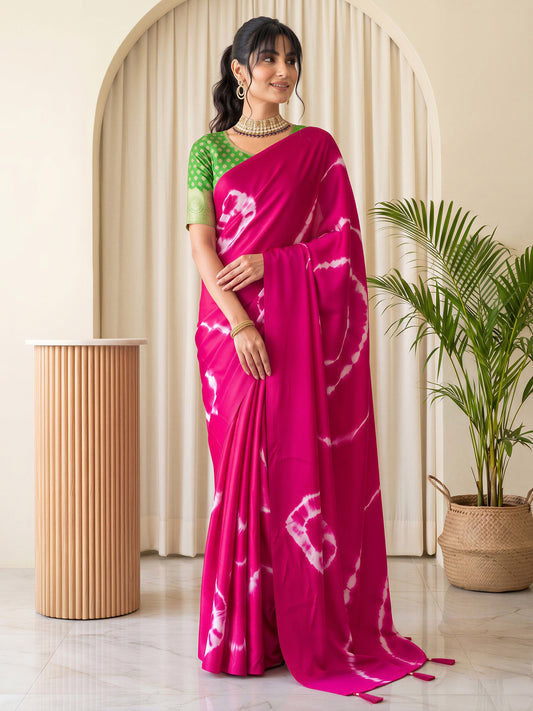 Woman wearing pink satin silk saree with tie-and-dye resist pattern and green blouse