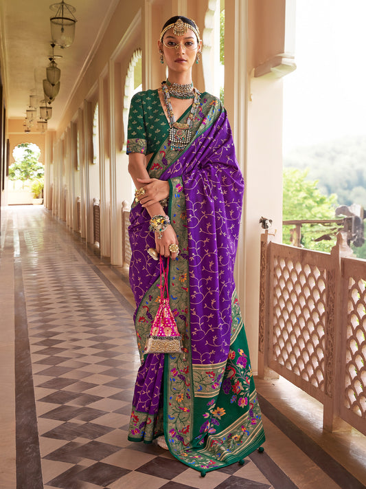 Woman wearing purple silk blend saree with all-over floral design and green blouse