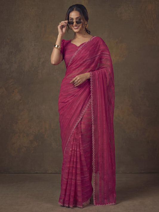 Woman wearing pink georgette saree with striped pattern design and pink blouse
