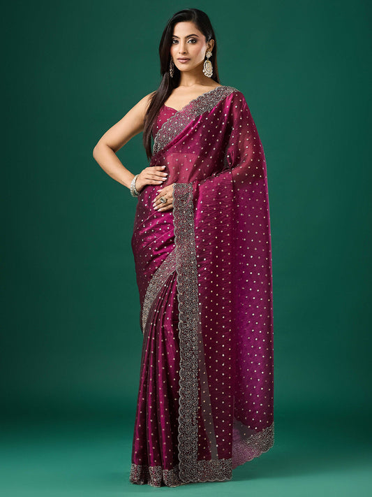 Woman wearing purple silk blend saree with ornamented surface design and purple blouse