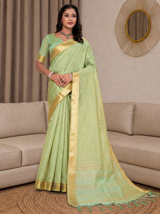 Woman wearing light green cotton silk saree with clean solid-tone finish and light green blouse