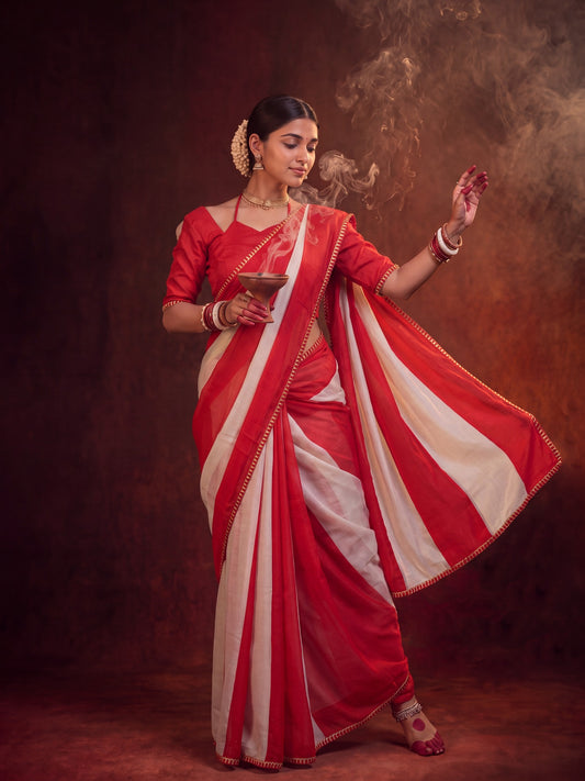 Woman wearing red chinnon saree with striped pattern design and red blouse