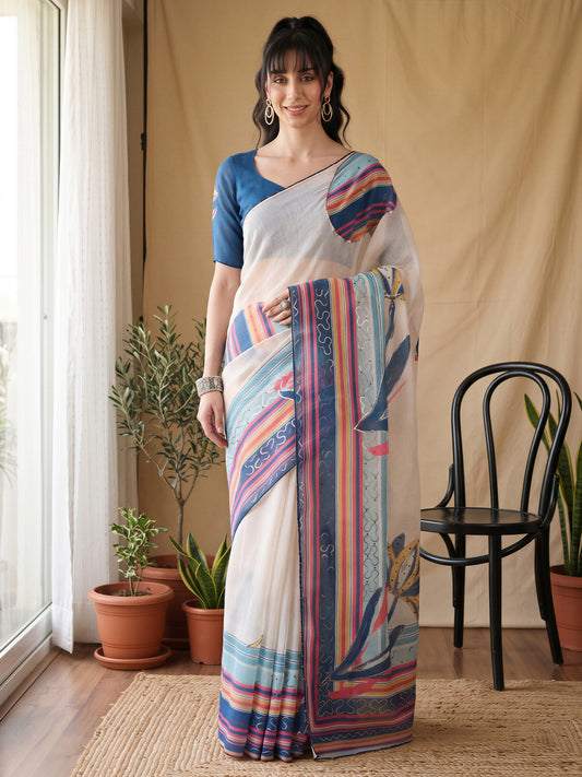 Woman wearing white organza saree with all-over floral design and teal blue blouse
