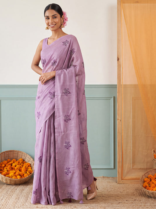 Woman wearing lavender kota doria cotton saree with embroidered motif work and lavender blouse