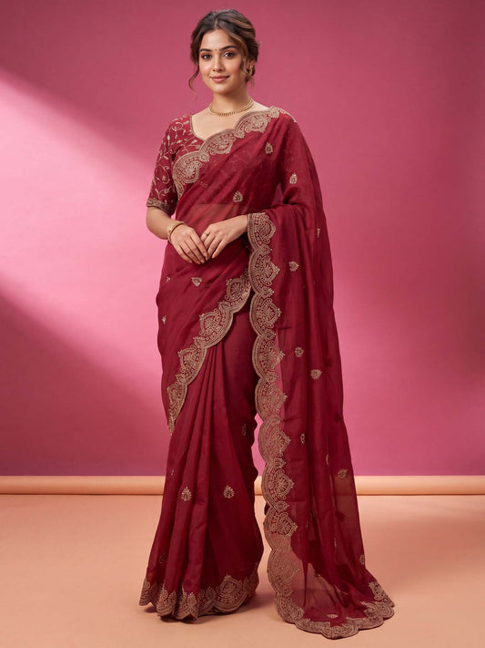 Woman wearing pink georgette saree with embroidered motif work and pink blouse