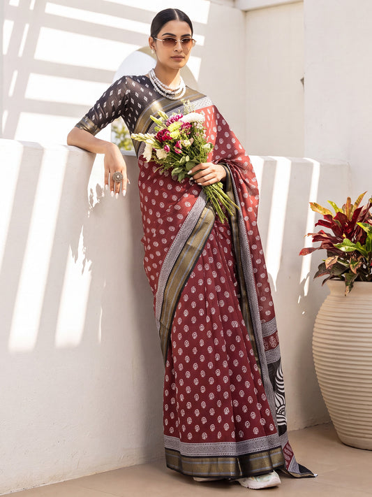 Woman wearing maroon cotton saree with dabu mud-resist print work and black blouse