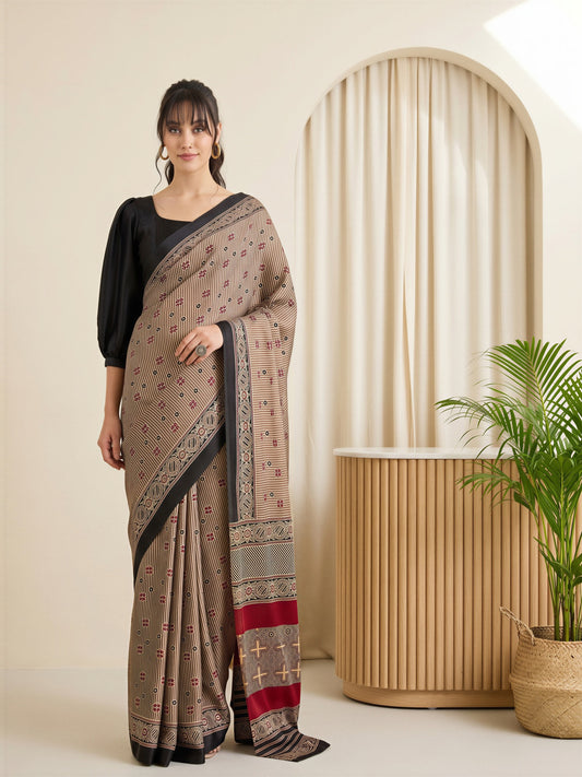 Woman wearing beige satin saree with striped pattern design and black blouse