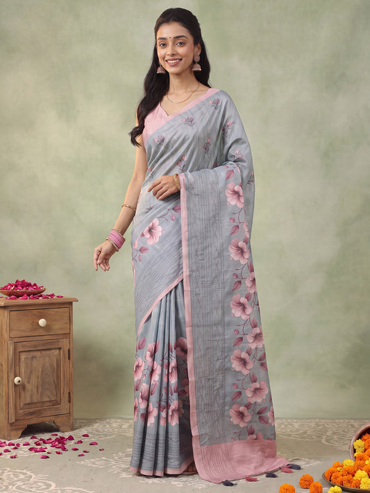 Woman wearing grey silk blend saree with all-over floral design and pink blouse