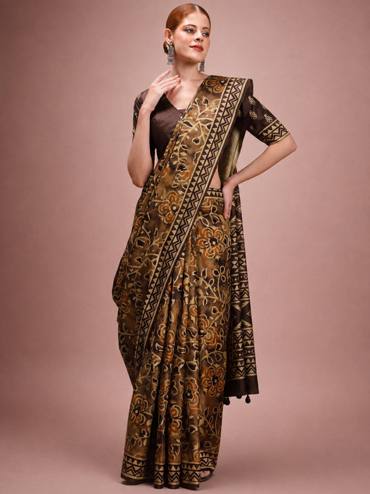 Woman wearing brown silk blend saree with traditional indian motif work and brown blouse