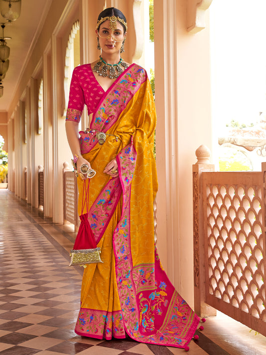 Woman wearing mustard silk blend saree with all-over floral design and pink blouse