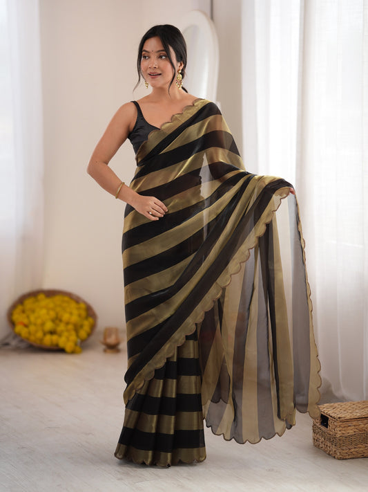 Woman wearing black satin saree with striped pattern design and black blouse