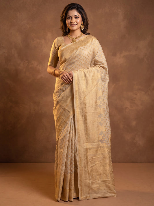 Woman wearing cream silk blend saree with zari butta (metallic motif) work and cream blouse