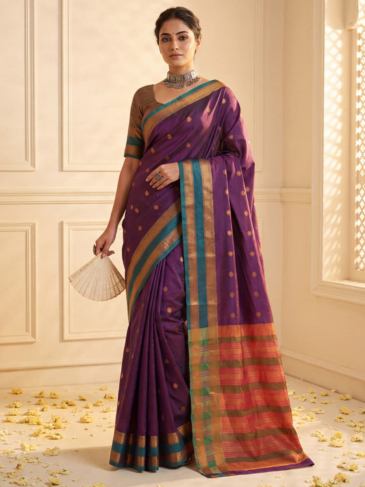 Woman wearing purple soft silk saree with zari butta (metallic motif) work and green blouse