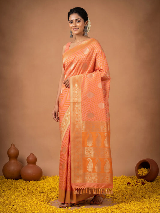 Woman wearing peach silk blend saree with geometric pattern design and peach blouse