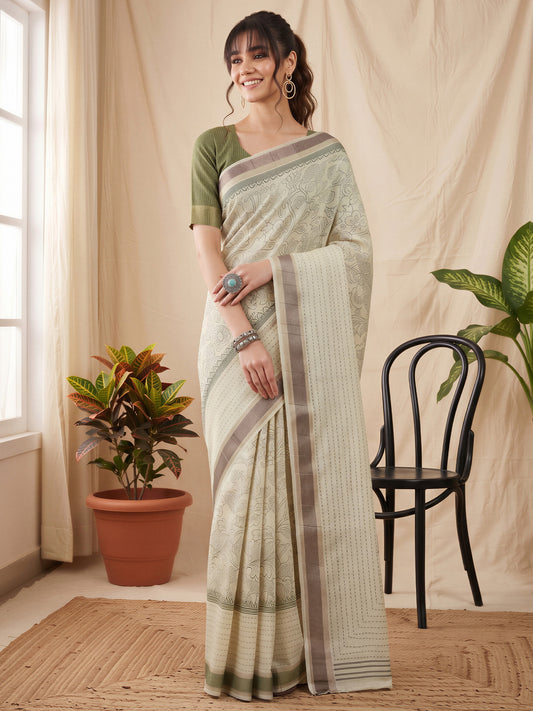 Woman wearing off white cotton silk saree with ornamented surface design and olive blouse