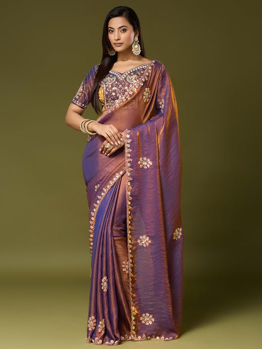 Woman wearing bronze satin silk saree with ornamented surface design and bronze blouse