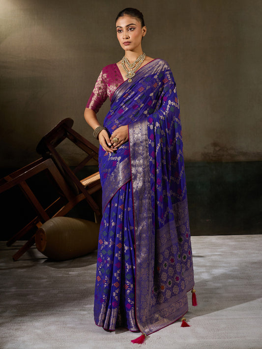 Woman wearing blue georgette saree with woven motif design and magenta blouse