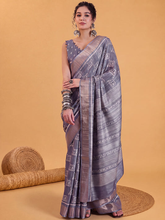 Woman wearing metallic silk blend saree with hand block-printed motifs and metallic blouse