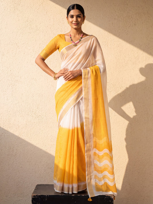 Woman wearing mustard linen saree with ombre graded colour work and white blouse