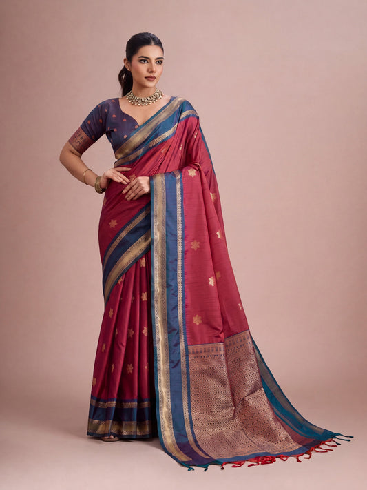 Woman wearing maroon tussar silk saree with traditional indian motif work and blue blouse