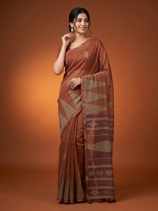 Woman wearing brown linen blend saree with geometric pattern design and coffee brown blouse