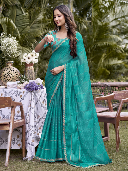 Woman wearing turquoise blue chiffon saree with traditional indian motif work and turquoise blue blouse