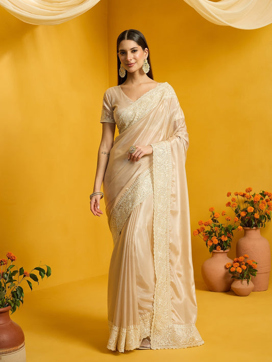 Woman wearing beige organza saree with clean solid-tone finish and beige blouse