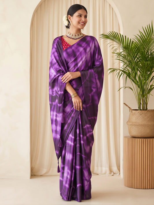 Woman wearing purple satin silk saree with tie-and-dye resist pattern and pink blouse