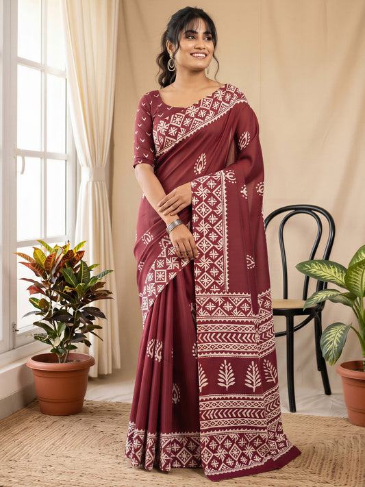 Woman wearing maroon cotton blend saree with batik wax-resist design and maroon blouse