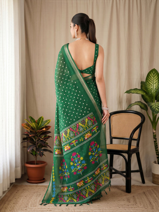 Woman wearing green georgette saree with bandhani tie-dye dot work and green blouse