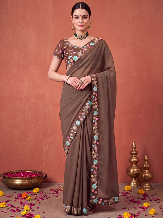 Woman wearing brown poly georgette saree with all-over floral design and brown blouse