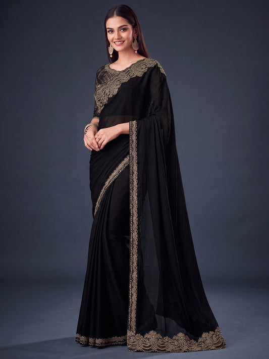 Woman wearing black satin silk saree with embroidered motif work and black blouse