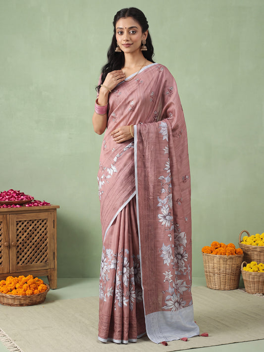 Woman wearing brown silk blend saree with all-over floral design and light blue blouse