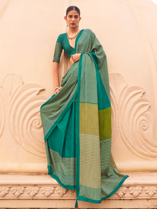 Woman wearing teal green silk blend saree with striped pattern design and teal green blouse