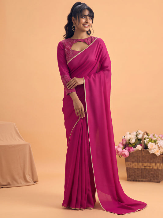Woman wearing pink silk saree with clean solid-tone finish and pink blouse