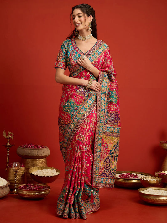 Woman wearing pink silk blend saree with traditional indian motif work and aqua blue blouse
