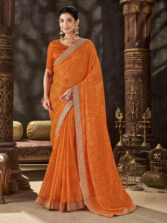 Woman wearing orange chiffon saree with bandhani tie-dye dot work and orange blouse