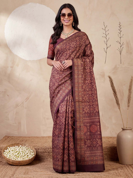 Woman wearing maroon silk blend saree with ajrak block-print motif work and maroon blouse