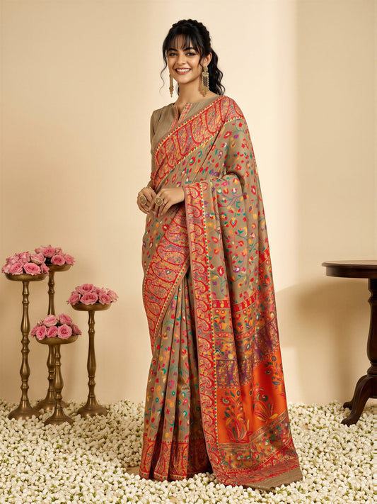 Woman wearing beige cotton silk saree with all-over floral design and beige blouse