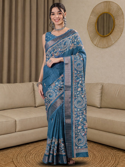 Woman wearing light blue silk blend saree with tribal folk-art motifs and light blue blouse