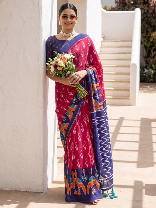 Woman wearing pink cotton saree with ikat resist-dyed pattern and navy blue blouse