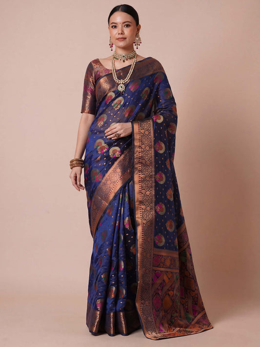 Woman wearing navy blue organza saree with zari butta (metallic motif) work and navy blue blouse