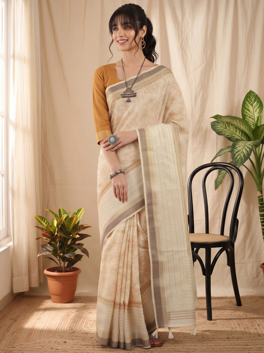 Woman wearing off white cotton silk saree with ornamented surface design and mustard blouse