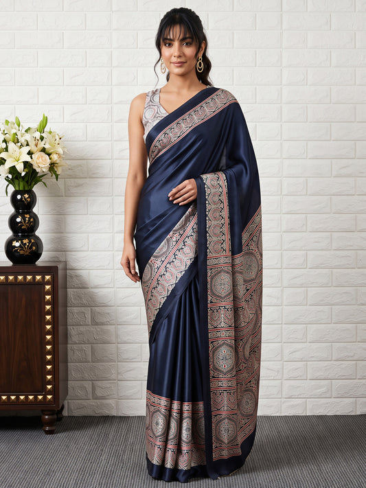 Woman wearing black satin saree with ajrak block-print motif work and black blouse